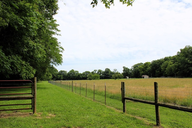 view of yard featuring a rural view and fence