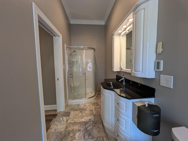 bathroom featuring vanity, baseboards, ornamental molding, a stall shower, and toilet