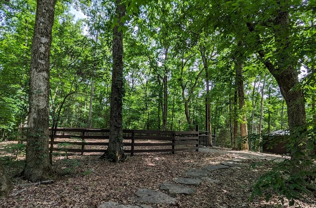 view of yard featuring a view of trees and fence