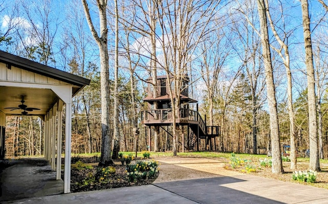 surrounding community featuring a view of trees and stairs