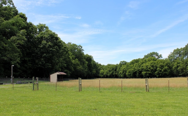 view of yard featuring a rural view and fence