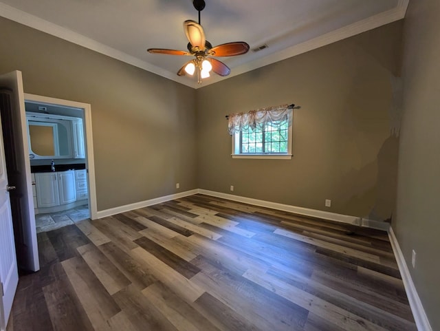 unfurnished bedroom featuring crown molding, ceiling fan, dark wood-type flooring, visible vents, and baseboards