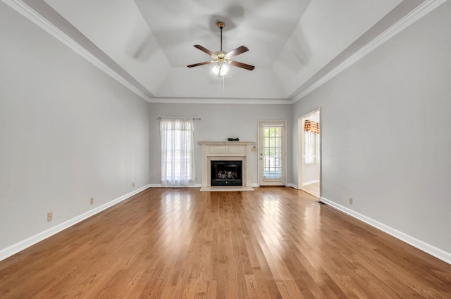 unfurnished living room with light wood-style flooring, baseboards, a ceiling fan, and a fireplace with raised hearth