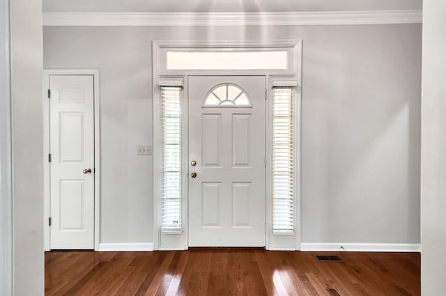 entrance foyer with baseboards, crown molding, and dark wood finished floors
