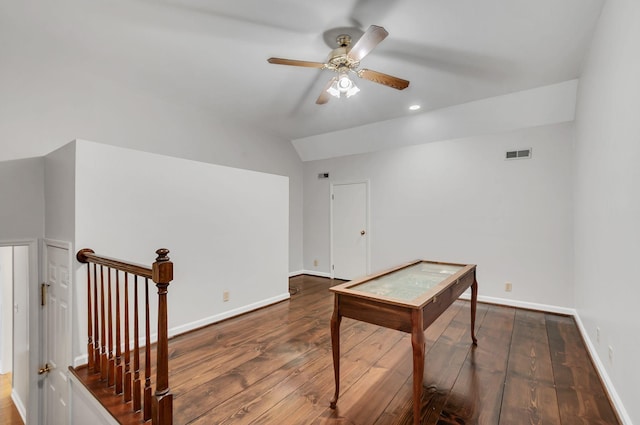 unfurnished office with visible vents, baseboards, a ceiling fan, hardwood / wood-style flooring, and vaulted ceiling