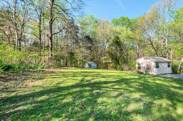view of yard with an outbuilding and a shed