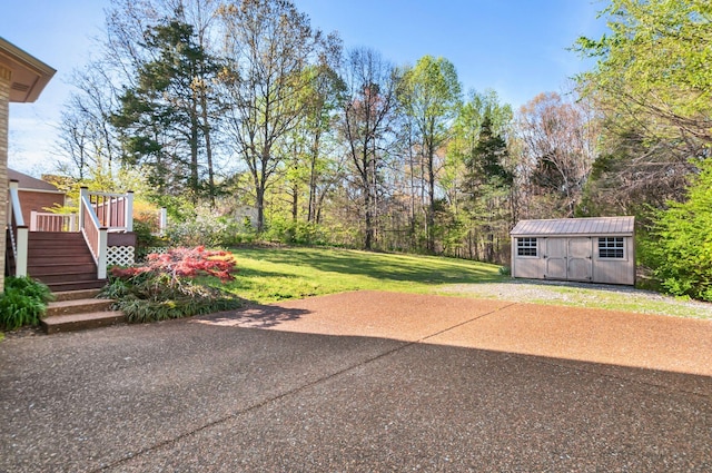 view of patio / terrace featuring a storage shed, a deck, an outdoor structure, and stairway