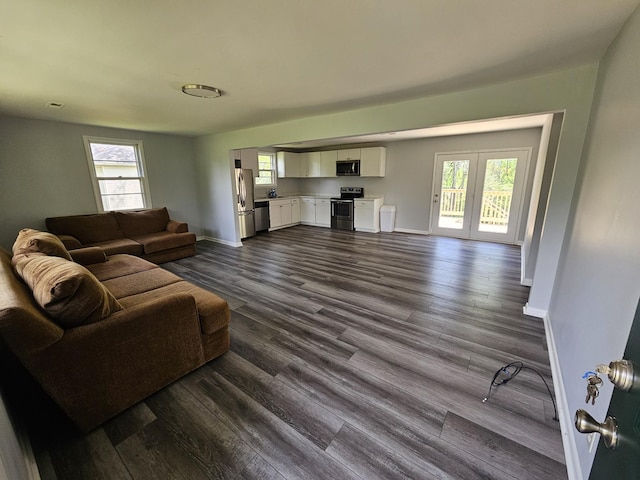 5006 Brookside Dr, Columbia, TN 38401 - living area with a wealth of natural light, dark wood-style flooring, and baseboards