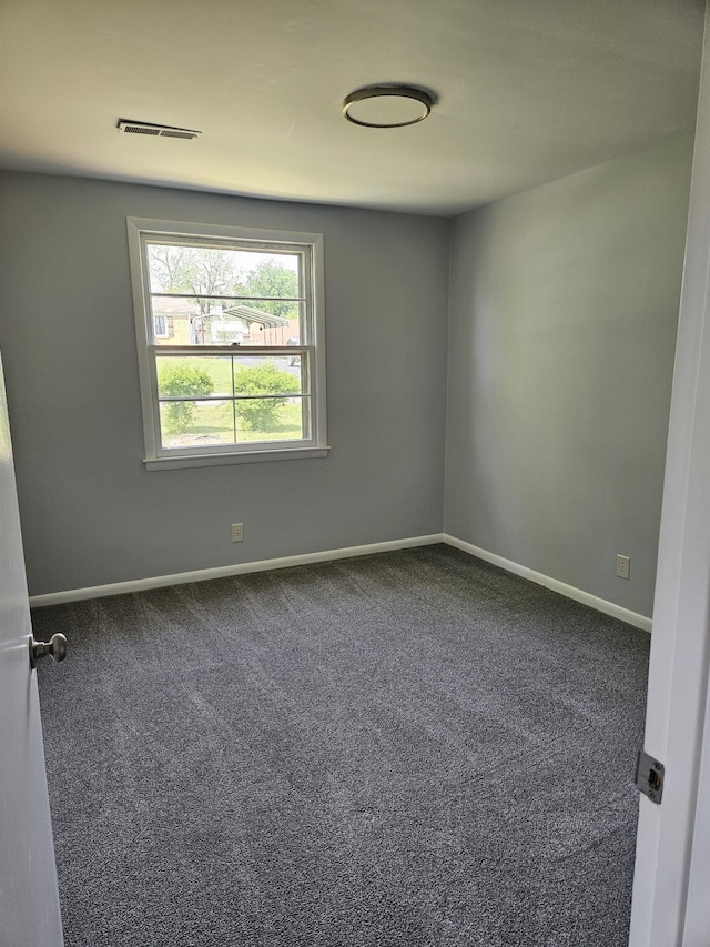 5006 Brookside Dr, Columbia, TN 38401 - empty room featuring dark carpet, baseboards, and visible vents