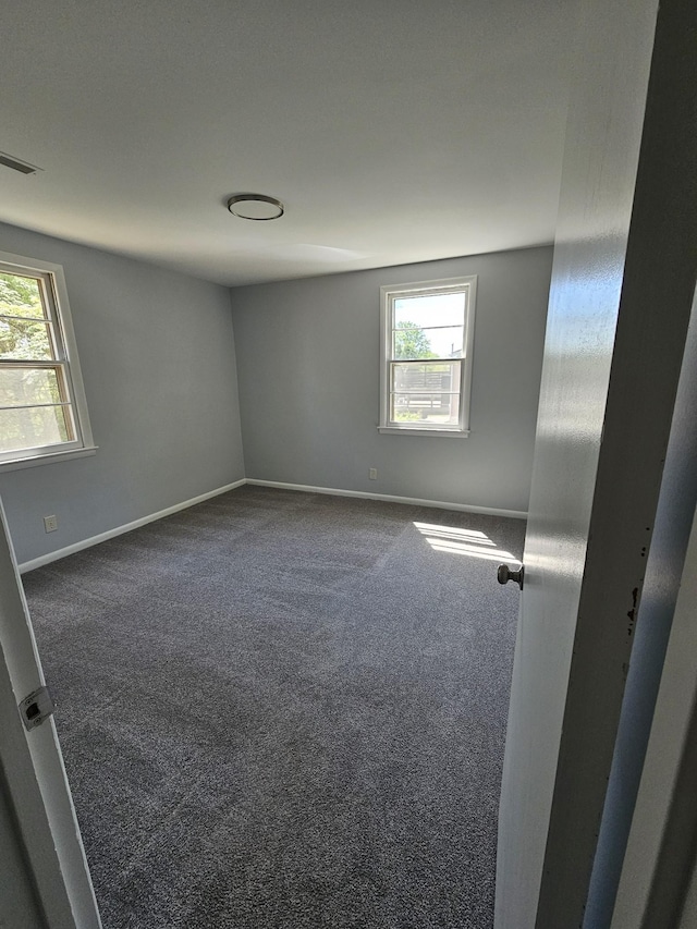 5006 Brookside Dr, Columbia, TN 38401 - empty room with dark carpet, a wealth of natural light, baseboards, and visible vents