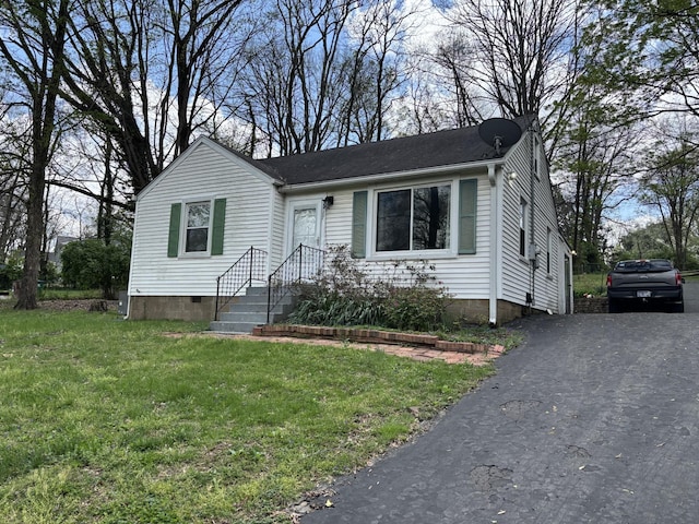 view of front of home with crawl space, driveway, and a front yard