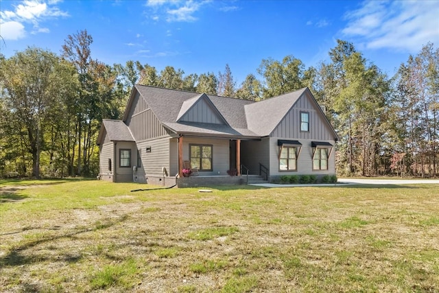 modern farmhouse style home featuring board and batten siding, a front yard, and a shingled roof