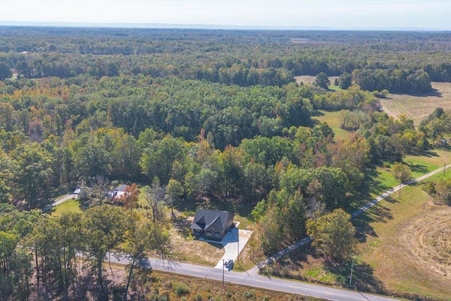 drone / aerial view featuring a forest view