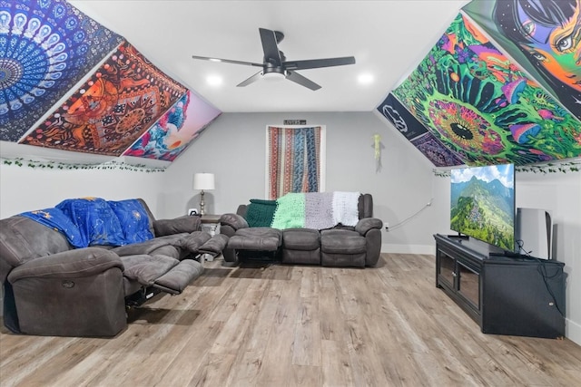 living room with wood finished floors, baseboards, a ceiling fan, and vaulted ceiling