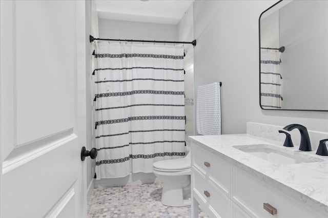 bathroom featuring toilet, curtained shower, and vanity