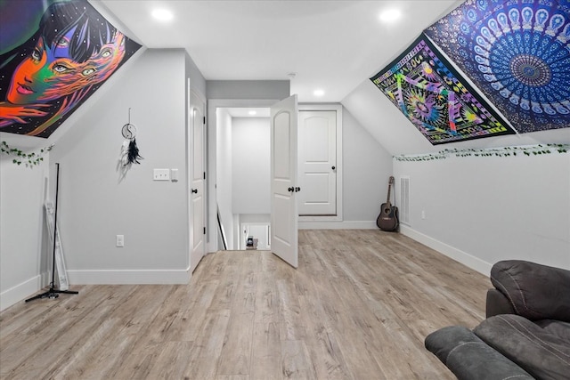 interior space with baseboards, recessed lighting, wood finished floors, and lofted ceiling