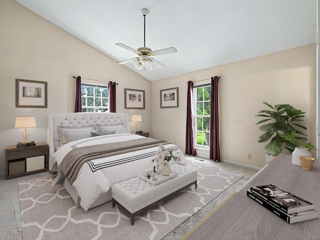bedroom with ceiling fan, a textured ceiling, vaulted ceiling, light carpet, and baseboards