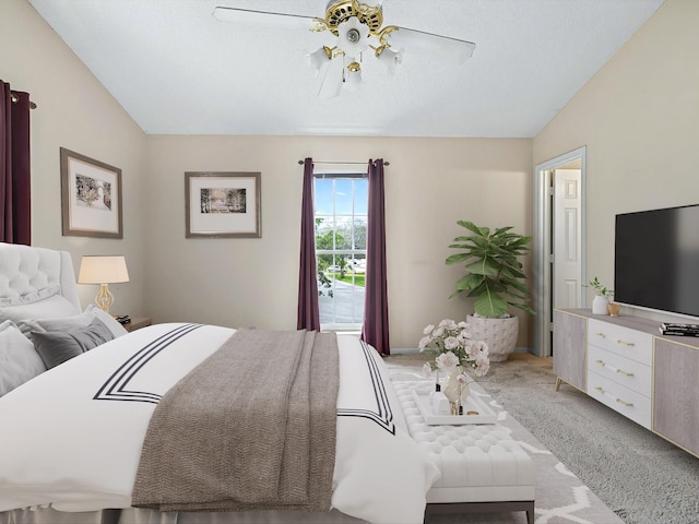 bedroom featuring a ceiling fan, vaulted ceiling, and light carpet