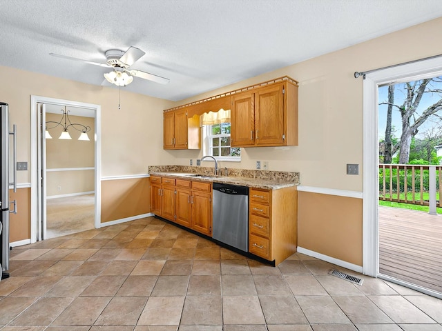 kitchen with visible vents, a sink, a ceiling fan, a textured ceiling, and stainless steel dishwasher