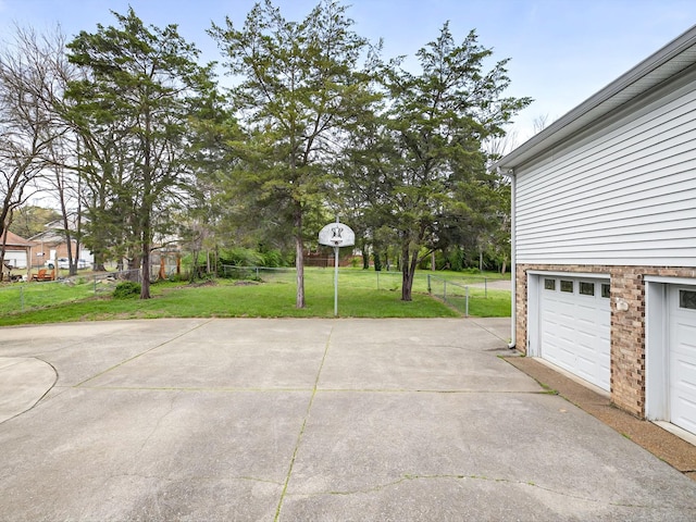 view of patio / terrace featuring fence and driveway