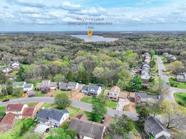 drone / aerial view featuring a forest view and a residential view