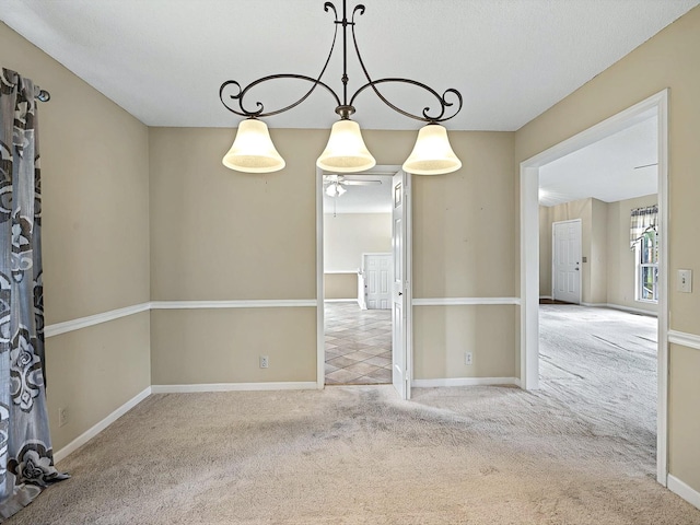 empty room with baseboards and carpet flooring