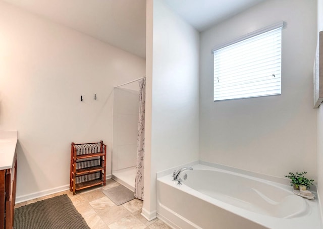 627 Prominence Rd, Columbia, TN 38401 - bathroom featuring a garden tub, vanity, a walk in shower, and baseboards