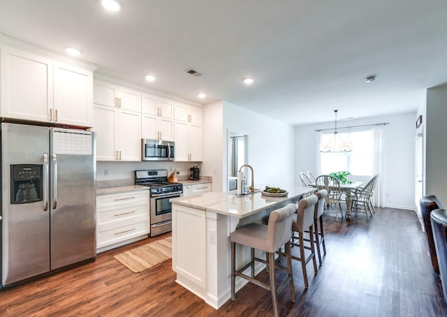 627 Prominence Rd, Columbia, TN 38401 - kitchen featuring stainless steel appliances, a sink, dark wood-style floors, a kitchen bar, and white cabinets