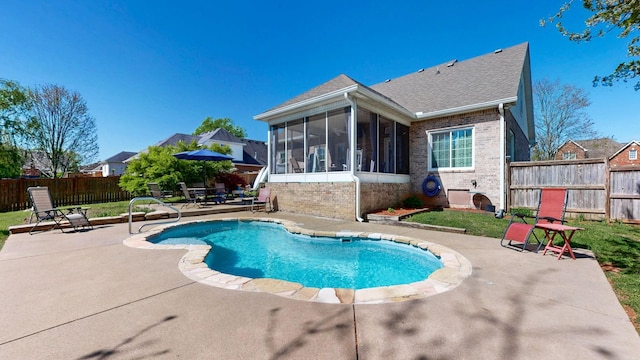 view of swimming pool with a patio area, a fenced backyard, a fenced in pool, and a sunroom