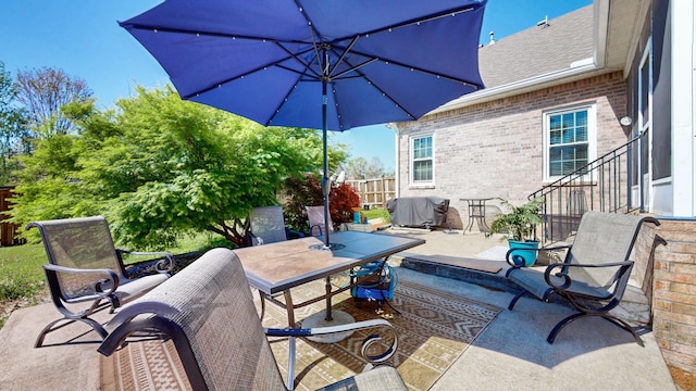 view of patio with fence and outdoor dining area