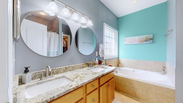 full bath with double vanity, a bath, tile patterned flooring, and a sink