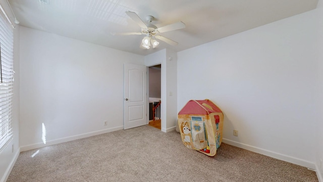 playroom featuring ceiling fan, baseboards, and carpet flooring