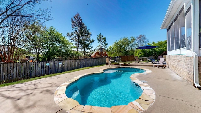 view of pool featuring a fenced backyard, a sunroom, a patio, and a fenced in pool