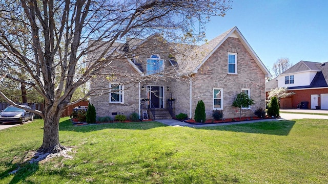 traditional-style home featuring brick siding, fence, crawl space, and a front yard