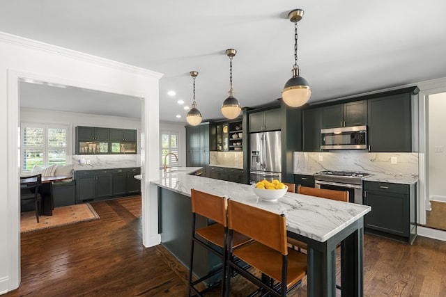kitchen with crown molding, dark wood-style floors, backsplash, and stainless steel appliances