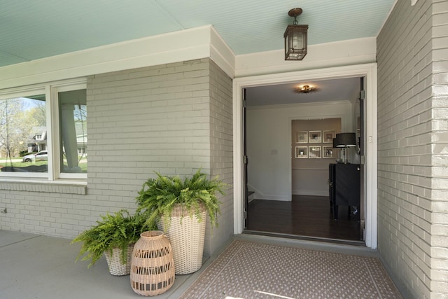 property entrance with brick siding