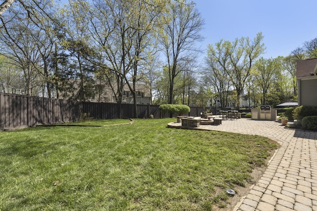 view of yard featuring a patio, a fire pit, and fence private yard