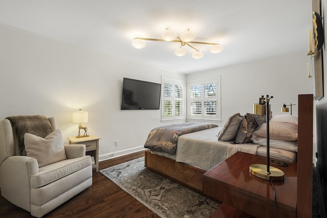 bedroom with dark wood-type flooring and baseboards