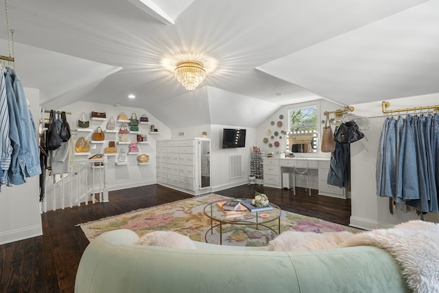 interior space with wood finished floors, visible vents, baseboards, and vaulted ceiling