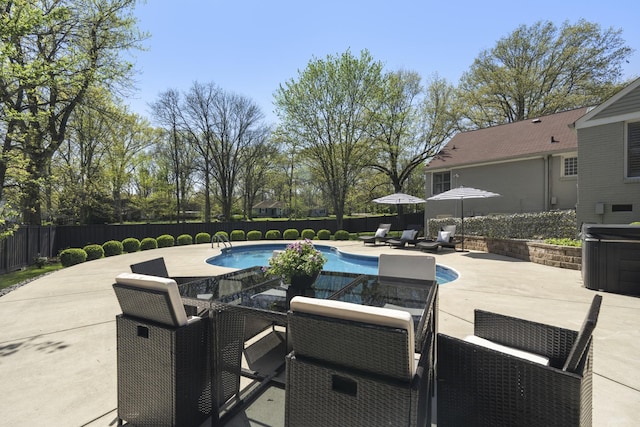 view of swimming pool featuring a fenced in pool, a patio area, a fenced backyard, and a hot tub
