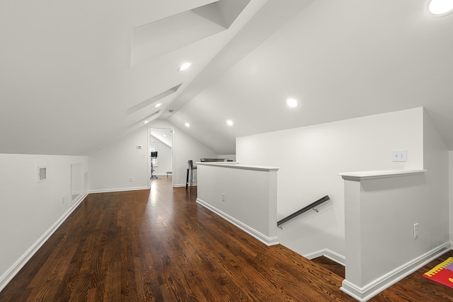 bonus room featuring visible vents, baseboards, lofted ceiling, and dark wood-style floors