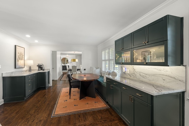 kitchen with recessed lighting, dark wood-type flooring, ornamental molding, and light stone counters