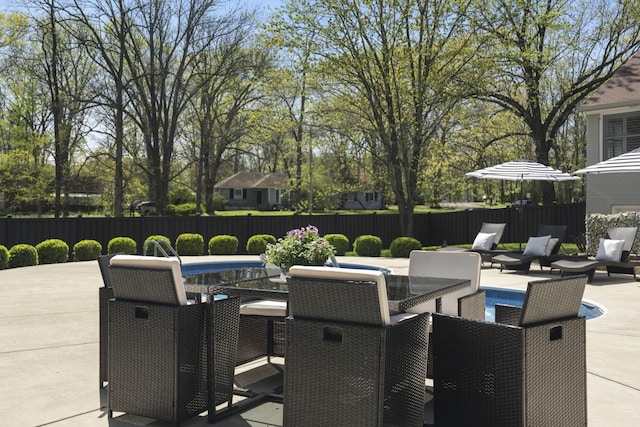 view of patio with outdoor dining area and fence private yard