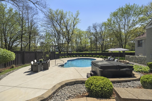 view of pool featuring a patio, a fenced backyard, a fenced in pool, and a hot tub