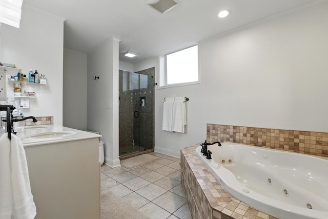 bathroom featuring a sink, a tub with jets, a shower stall, double vanity, and tile patterned flooring