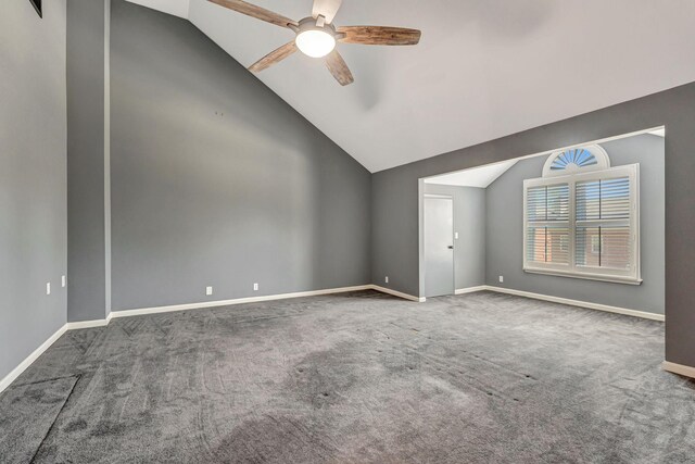 carpeted empty room featuring lofted ceiling, baseboards, and ceiling fan