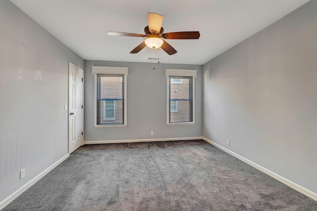 unfurnished room featuring visible vents, baseboards, a ceiling fan, and carpet floors