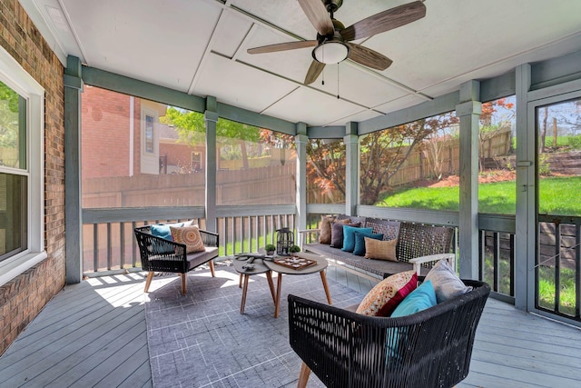 sunroom / solarium featuring an outdoor hangout area and a ceiling fan