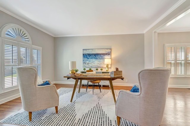 office space featuring baseboards, crown molding, and wood finished floors