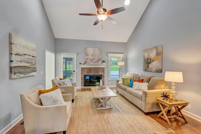 living area with a healthy amount of sunlight, wood finished floors, and a ceiling fan